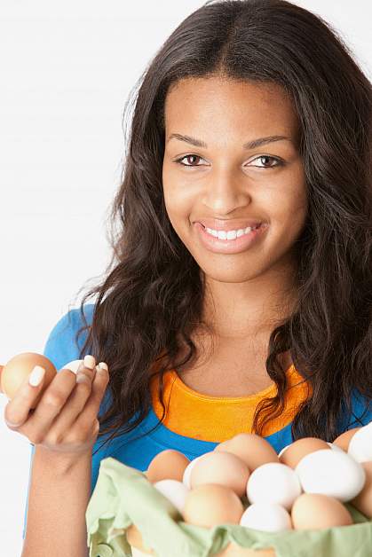 Teenager holding eggs.