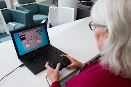 Older woman playing a computer game