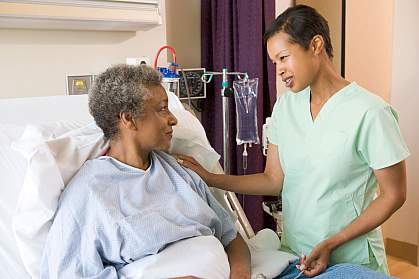 Nurse helping hospital patient.