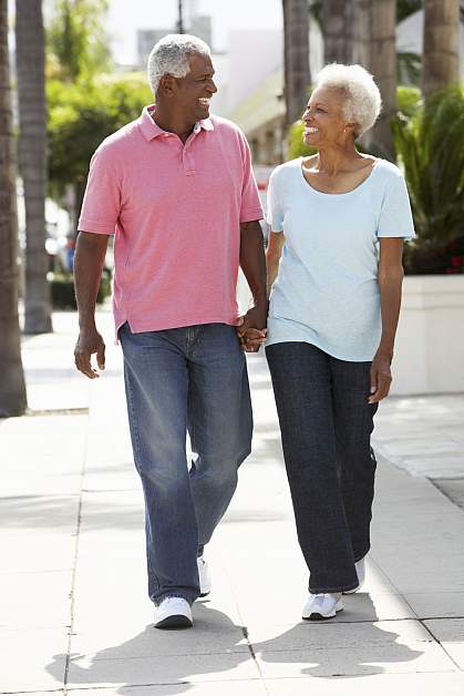 Senior couple walking along the street together.