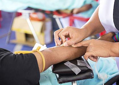 Arm of a person donating blood.