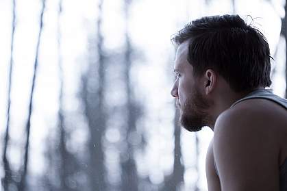 Man looking out a window.