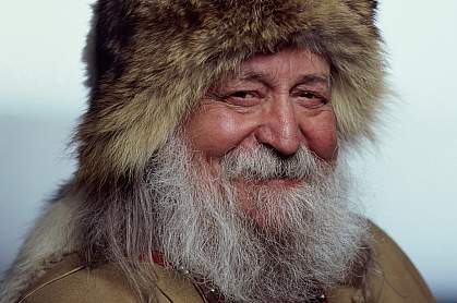 Portrait of a senior Inuit man smiling.