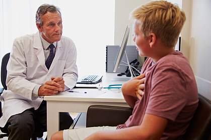 Teenage boy in consultation with doctor.