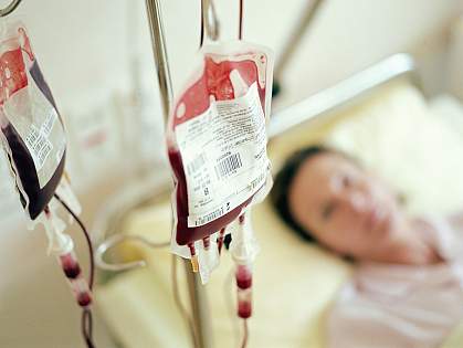 Woman in hospital bed getting blood transfusion