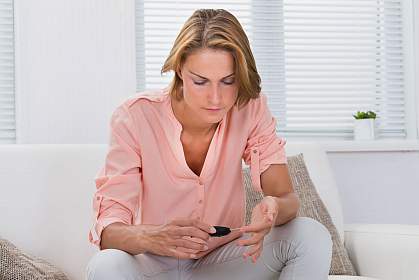 Woman checking blood sugar level