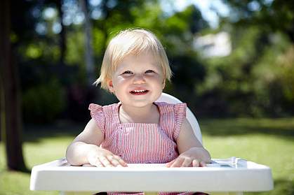 Baby waiting for lunch in a garden