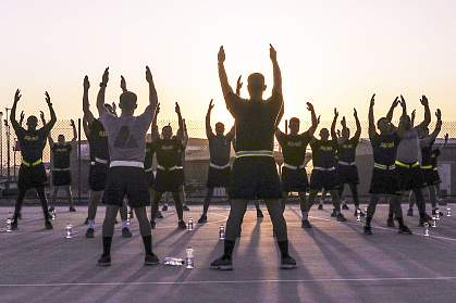 Soldiers stretch during sunrise before an early morning run