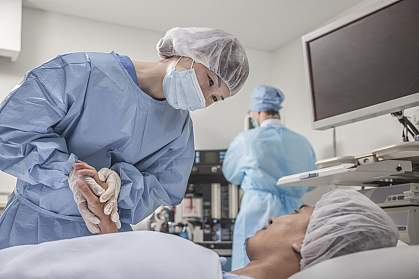 Surgeon holding a patient’s hands as they prepare for surgery.