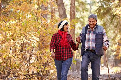Senior African American couple walking through the woods