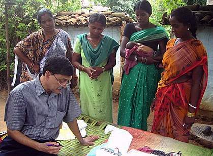 Doctor with four women, one holding a baby