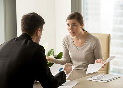 Stressed woman arguing with colleague at work
