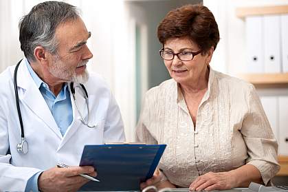 Doctor talking to female senior patient