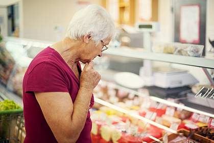 Woman examining cheeses at a market