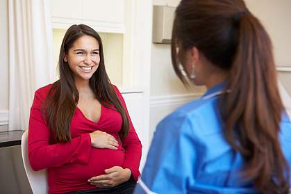 A pregnant woman talking to a health care professional