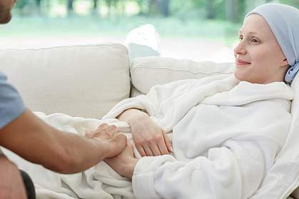 Male nurse supporting a woman battling cancer holding her hand