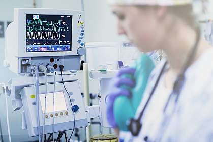 Nurse monitoring patient’s vitals