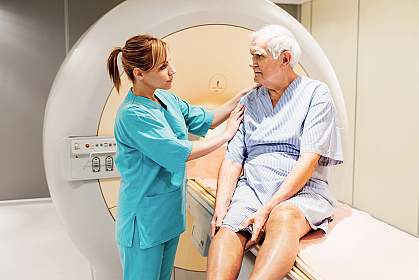 Female nurse preparing a mature patient for an MRI Scan.