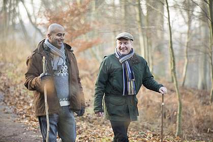 Two older men on a winter walk.