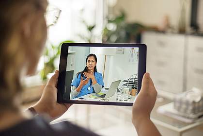 Patient talking to a doctor using a digital tablet