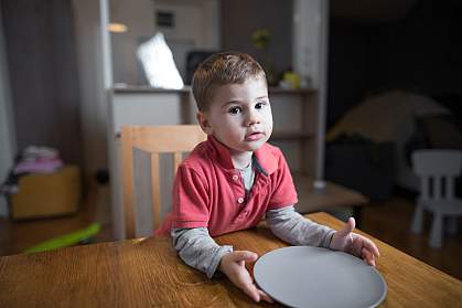 Young boy with empty plate