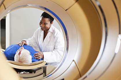 Radiologist preparing patient for PET imaging scan