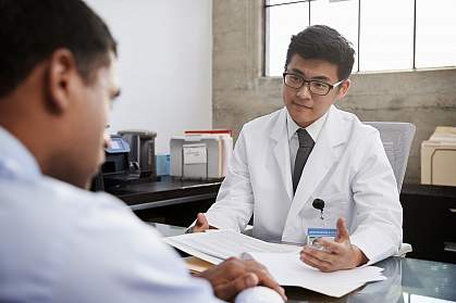 Doctor in consultation with male patient