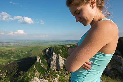 Woman with goosebumps overlooking a mountain range
