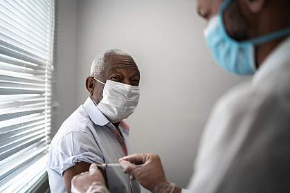 Mature black man getting vaccination