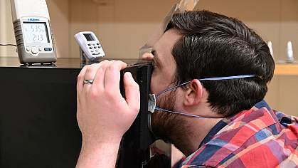 Person breathing into sealed box