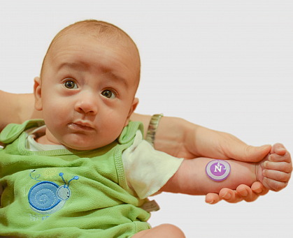 Baby with sweat sticker on arm