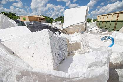 Pile of used polystyrene packing material at waste dump.