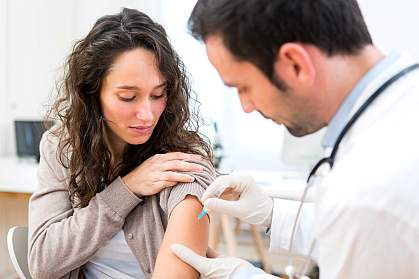 Young woman being vaccinated.