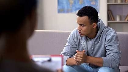 Teenaged boy in session with health professional.