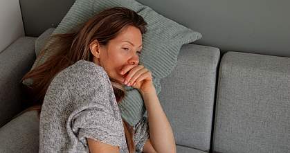 Tired woman lying on sofa.