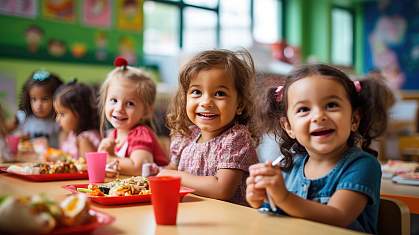 Group of AI-generated preschoolers sitting in the school cafeteria eating lunch.