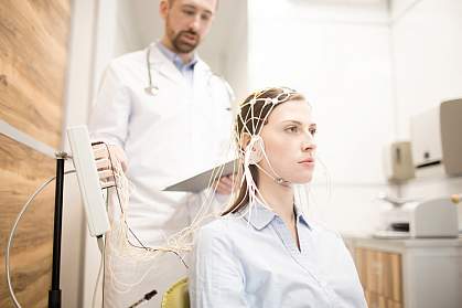 Young woman undergoing electroencephalography.