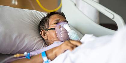 Old woman with Ventilator mask on Hospital bed - stock photo