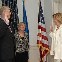 Dr. Francis Collins, joined by wife Diane Baker, is sworn in as the 16th NIH director by head of NIH human resources Chris Major.