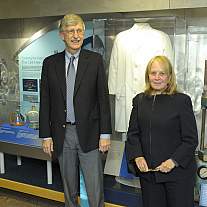 Francis Collins and Dr. Myrna Weissman, widow of Dr. Marshall W. Nirenberg, stand before an exhibit honoring NIH’s first intramural Nobelist.
