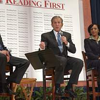 President George W. Bush speaks into a microphone