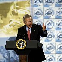 President George W. Bush speaks at a podium