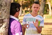 Teenager in park turning down an vape cigarette