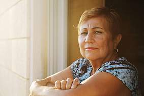 Image of a woman looking out a window