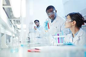 Image of three young scientists working in a lab