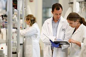 NIH researchers discussing research results in a laboratory.
