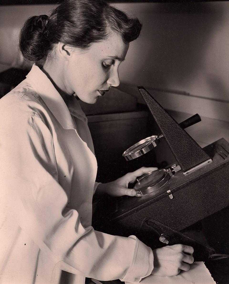 Ruth Kirschstein looking at a microscope