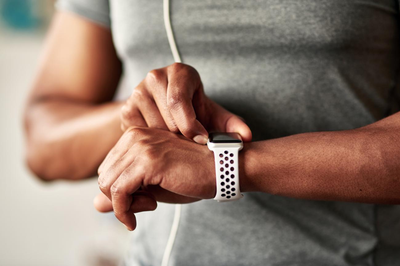 wearable-man.jpg Fitness man taking a break, checking activity tracker