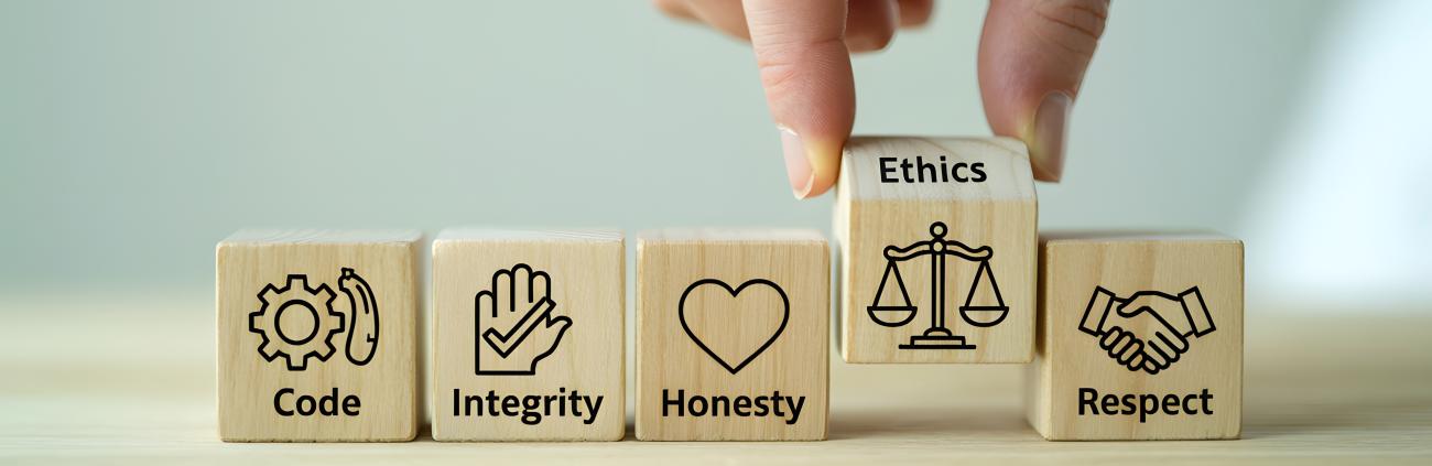 Photo of small wooden blocks with the words code, integrity, honest, ethics, and respect