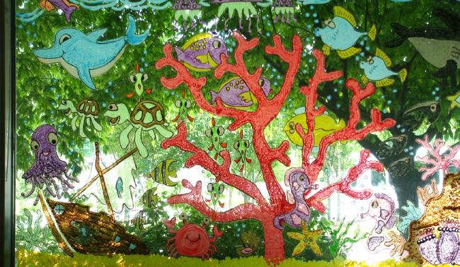 Painting of coral and sea creatures on a window